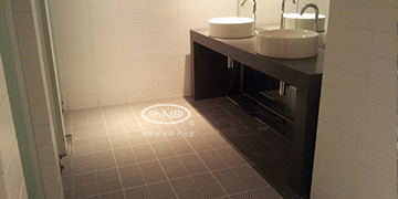 How should the bathroom anti-slip mats be cleaned and maintained?